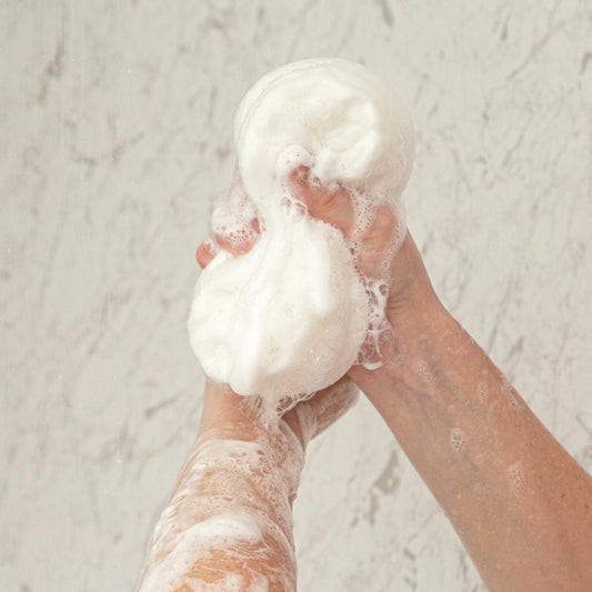 Person holding dove soap sponge